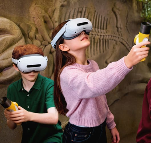 Adults in MR headsets reaching up toward something only they can see